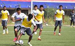 Bengaluru FC skipper Sunil Chhetri vies for possession with midfielder Alwyn George in training at the Bangalore Football Stadium