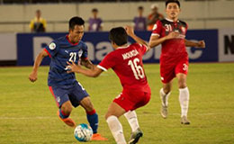 Bengaluru FC striker Udanta Kumam is stopped in his tracked by Lao Toyota FCs Souksavath Moukda at the National Stadium in Vientiane Laos