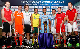THe captains of the eight participating teams at the Hero Hockey World League final stand with the trophy