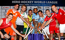 THe captains of the eight participating teams at the Hero Hockey World League final stand with the trophy1