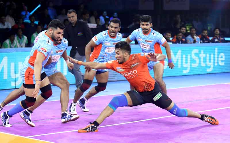 Arjun Deshwal of U Mumba tries to raid past the strong defence of Bengal Warriors