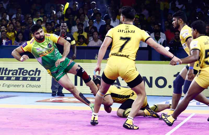 Patna Pirates star raider Pardeep Narwal ankle held by Telugu Titans Captain Abozar Mohajermighani