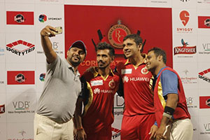 Selfie time for Manvinder Bisla and Yuzvendra Chahal as they pose with the two captains from HCL and FlipKart before the T 20 finals of the Royal Challengers Bangalore Corporate Cricket Championship