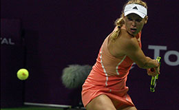Caroline Wozniacki of Denmark returns to Ana Konjuh of Croatia during her first round match at the WTA Qatar Total Open